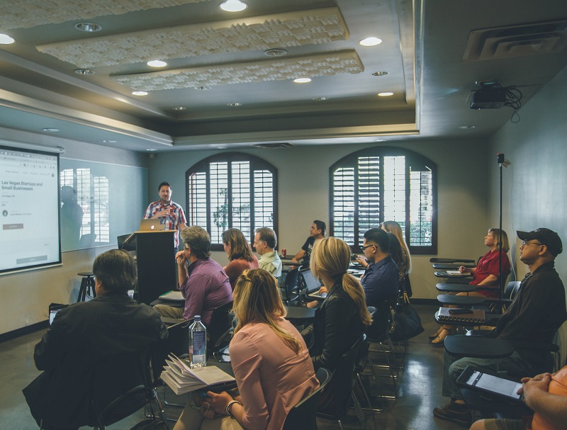 A trainer presenting to a group of housing professionals
